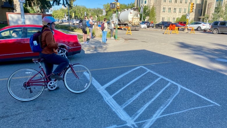 A person on a bike at the bike box