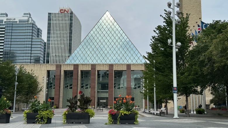 Light reflects off the glass pyramid that rises out of Edmonton city hall on a sunny, fall afternoon. 