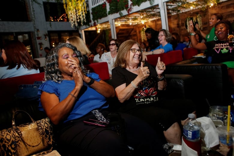 Happy women giving thumbs up