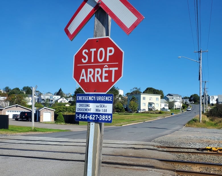 A stop sign at a rail crossing