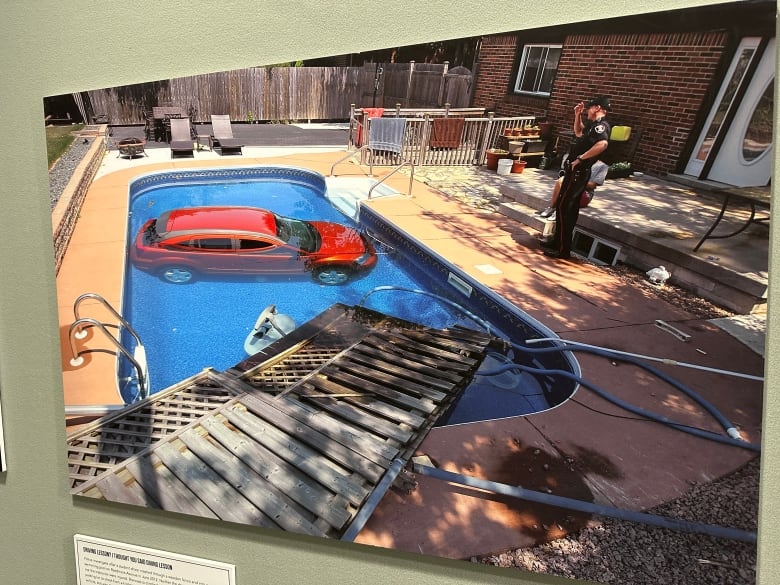 A photo of a vehicle in a backyard pool.