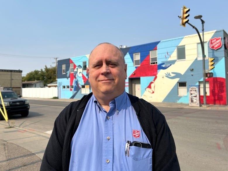 A man in a blue shirt.