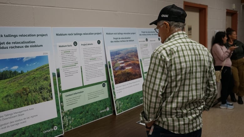 A Nairn and Hyman township resident reads posters and pamphlets containing information about niobium waste relocation project during the Town Hall.