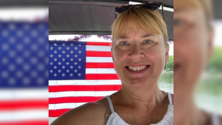 A portrait of a person in front of an American flag.