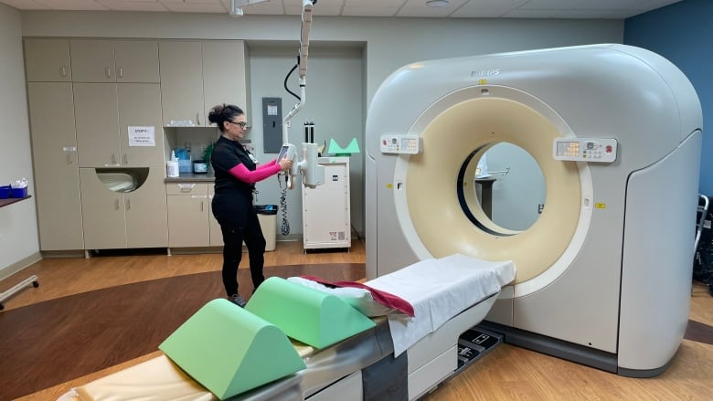 A woman standing in front of some medical equipment