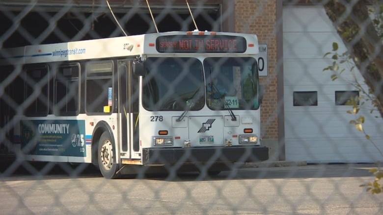 A bus is driving out of a garage.