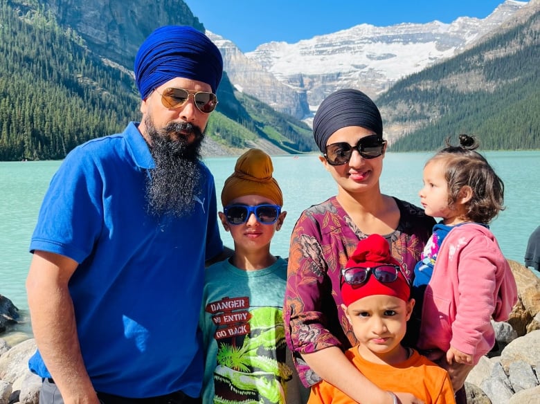 A family of five is pictured in the mountains.