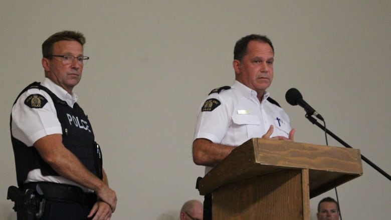 RCMP Supt. Andy LeClair, left, and RCMP Insp. Mike Berry, present to an audience.