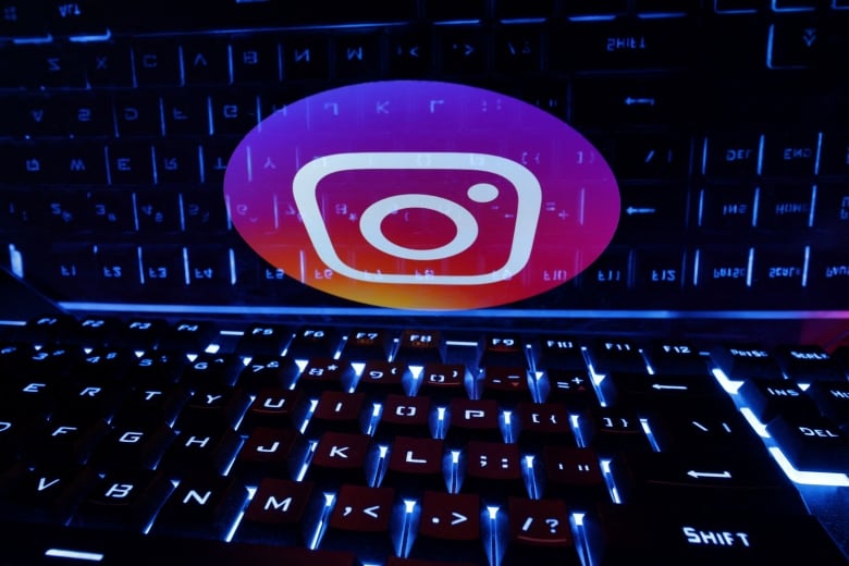 A keyboard is shown, as well as the pink logo for the app Instagram.