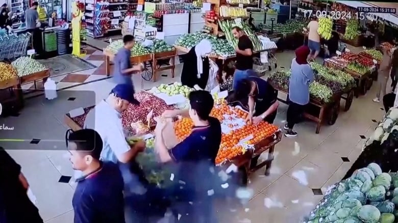 A man's bag is seen exploding in a supermarket in Beirut, Lebanon.