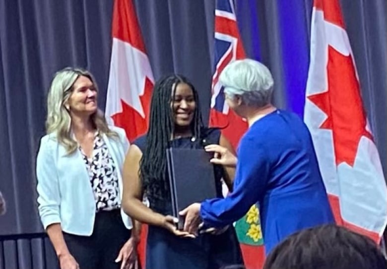 Lladaneyah Gayle accepts the Lincoln M. Alexander Award from Ontario Lieutenant Governor Edith Dumont and education minister Jill Dunlop on Sept. 16 in Toronto, Ont.