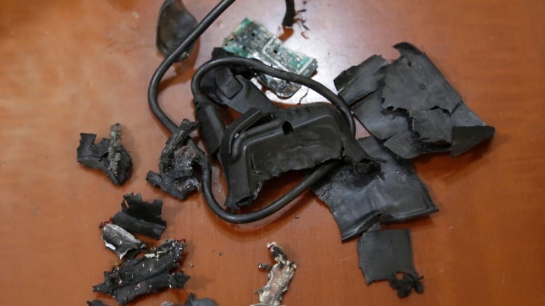 Remains of an exploded pager on display on a surface.