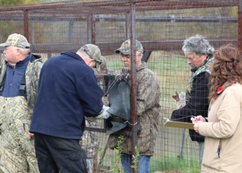 A team works to band a bird at Jack Miner Migratory Bird Sanctuary.