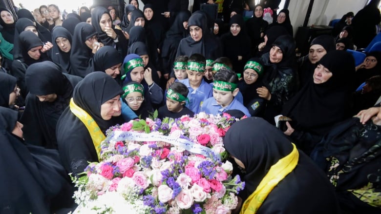 Mourners surround the coffin of a 10-year-old girl who was killed in explosions in Lebanon on Sept. 17, 2024.