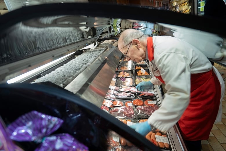 man at meat counter