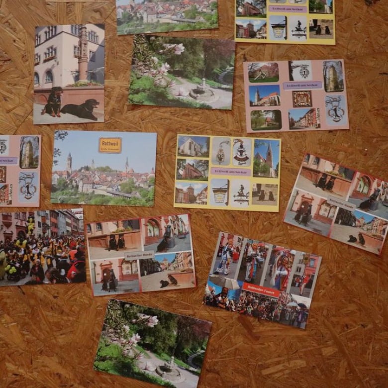 Colourful post cards spread across the floor. 