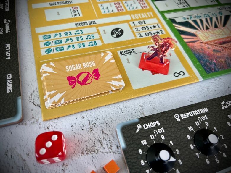 Image of a board game with cards that have an illustration of a wrapped candy with 