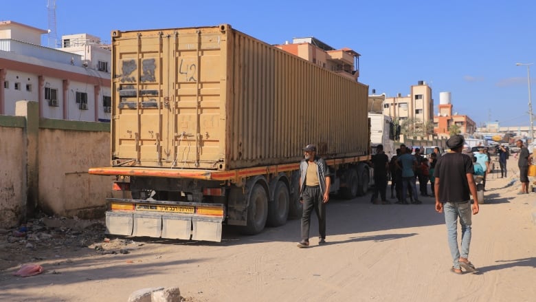 People seen standing next to a truck in Gaza.