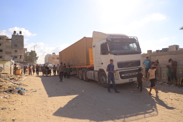 People seen standing next to a truck in Gaza.