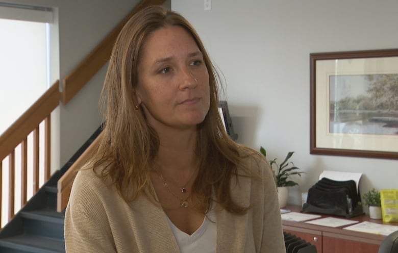 Woman stands for interview looking right