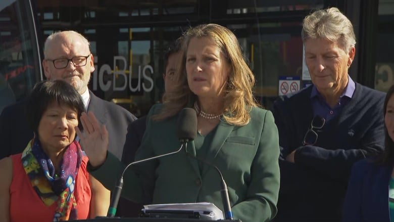 Woman in a suit at a news conference