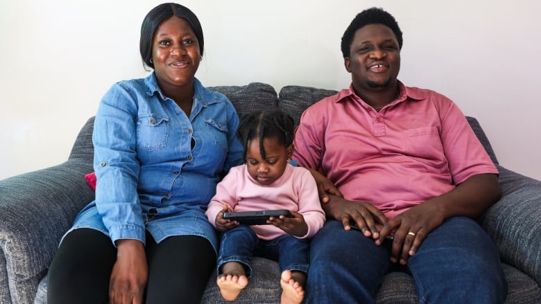 Oluwatomi Waziri with his wife Maria and daughter at their apartment in Winnipeg. He says, through years of overcoming depression, he and his wife finally decided to move to Winnipeg in November last year but a long waitlist for daycare has impacted his career and forced him to become a stay-at-home dad. 