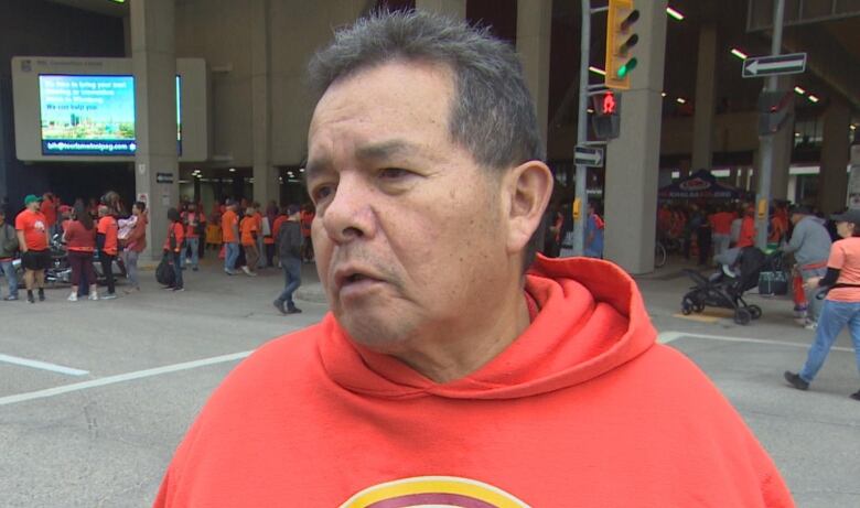 A man in an orange shirt.