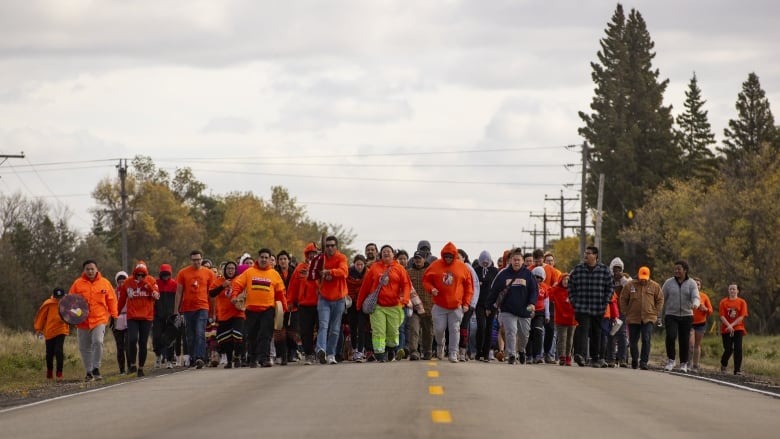 Hundreds walk down Grand Valley Road for Brandons Orange Shirt Day Walk.