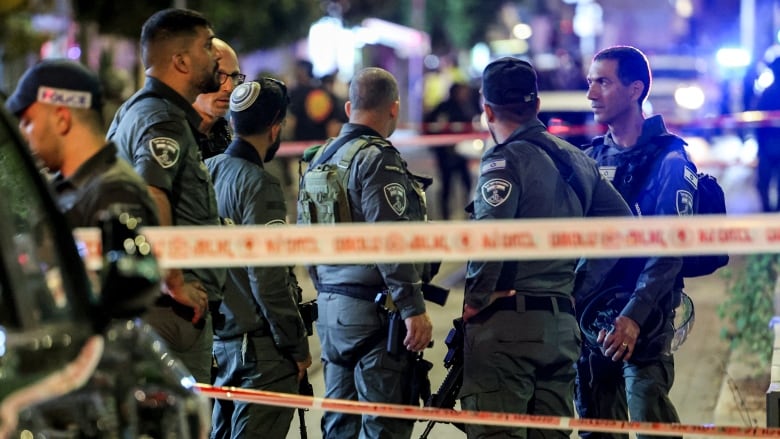 Israeli border guards are seen deploying at the scene of a shooting attack in Jaffa, south of Tel Aviv, on Tuesday.