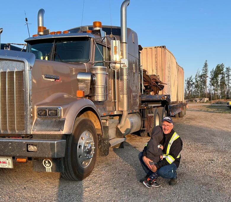 Man in safety vest next to truck