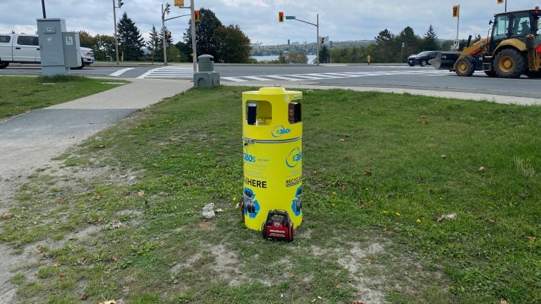 A bring yellow cylindrical container.