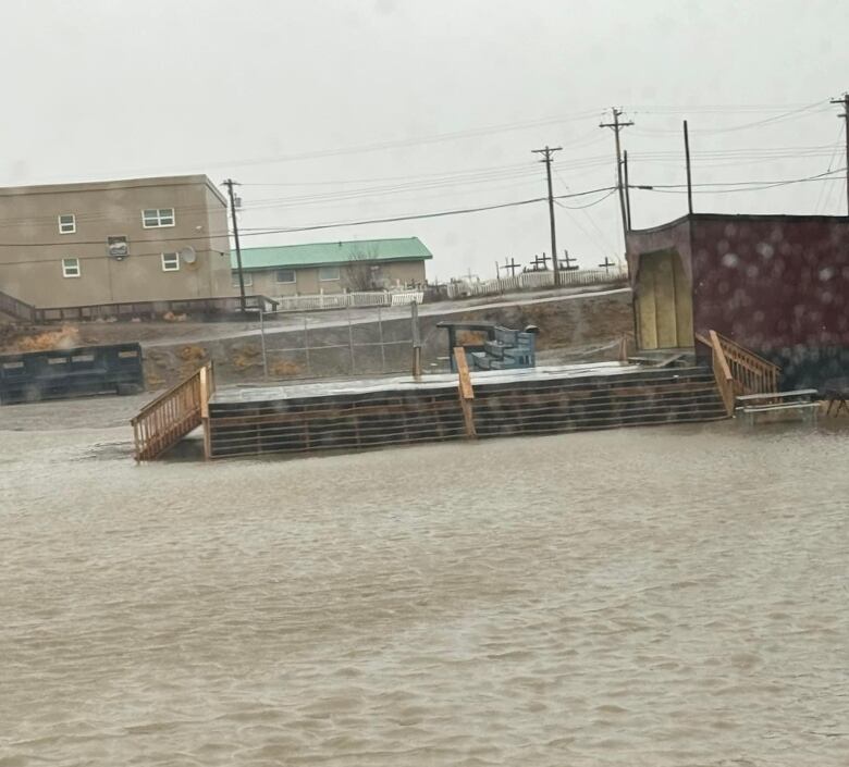 Water can be seen up to steps in Tuktoyaktuk over the weekend