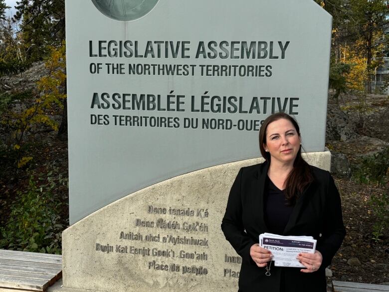 Josee-Anne Spirito stands in front of a sign for the NWT Legislative Assembly.