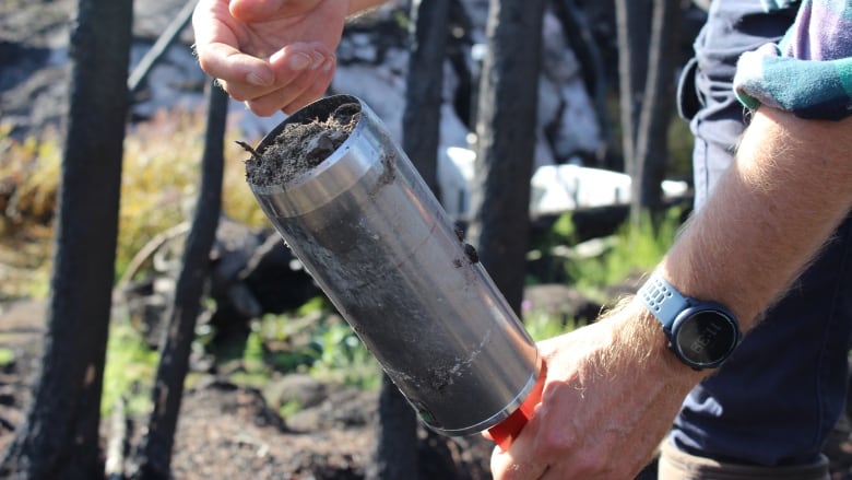 A man with a metal tube in his hands.