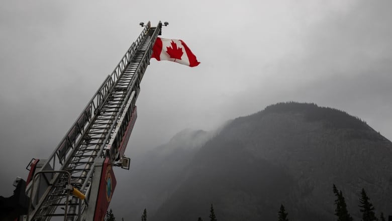 A Canadian flag hangs over the highway 