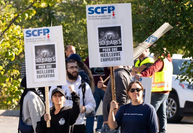 Port of Montreal longshore workers are seen striking. 