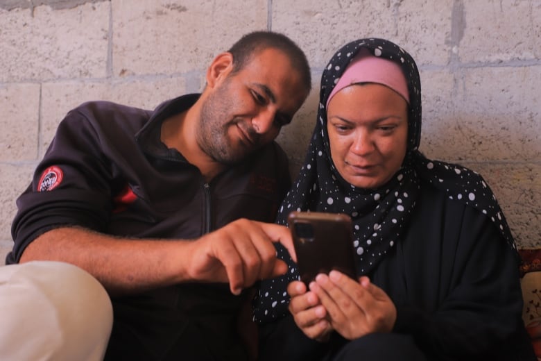 Heba and Saleh Idris on a video call with their 14-month-old daughter.