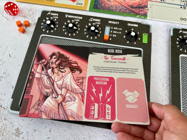 Illustration of a woman singing with a microphone on a card from a board game.