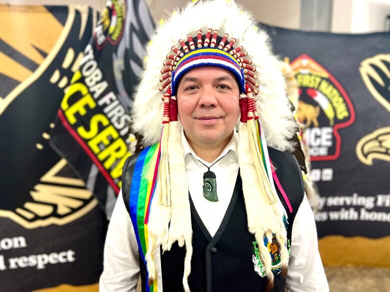 An Indigenous man wearing a traditional headdress. 