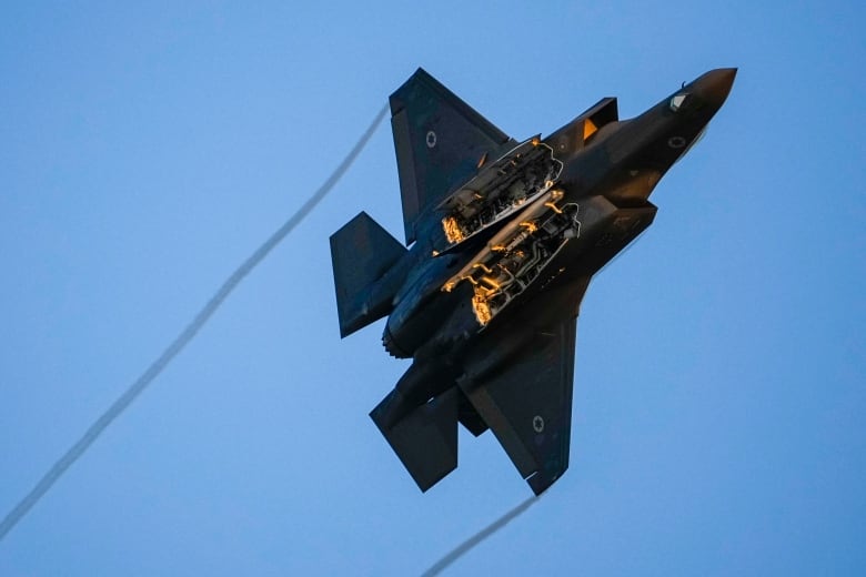 An Israeli air force F-35 war plane flies over during a graduation ceremony for new pilots in Hatzerim air force base near the southern Israeli city of Beersheba, Israel, Thursday, June 29, 2023. 