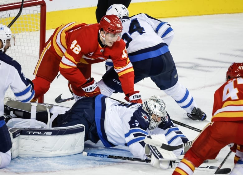 Hockey players colliding near the goal