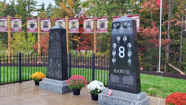 Two monuments with photos of those they are honouring behind them. 