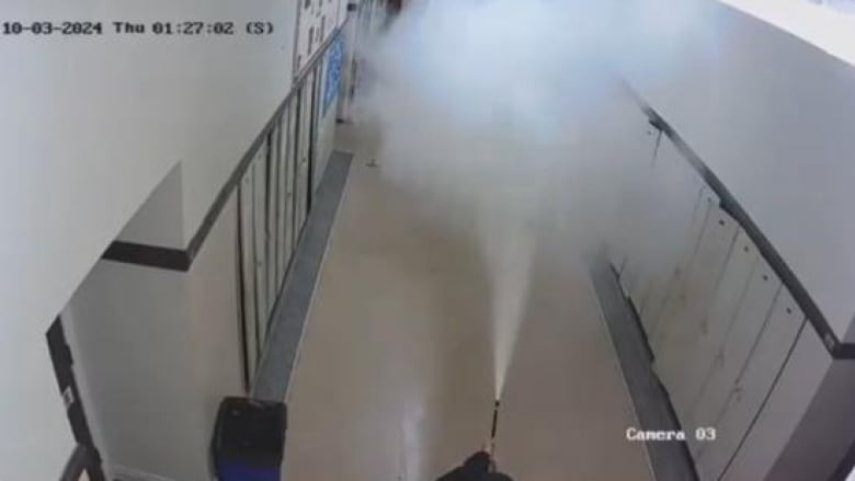 What appears to be a fire extinguisher is sprayed down a school hallway at Windsor Islamic High School.