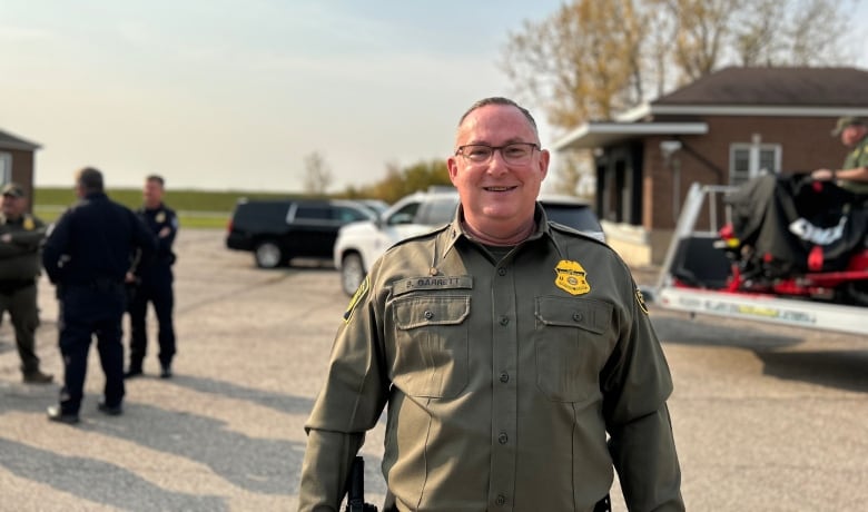 A man in a U.S. border patrol uniform poses for a photo. 