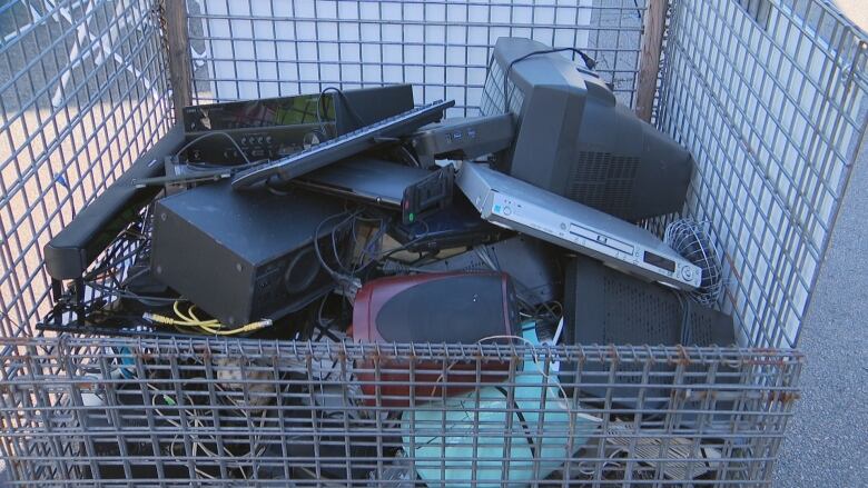 A cart filled with old electronic equipment