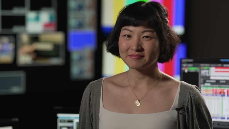 A woman smiles for the camera.