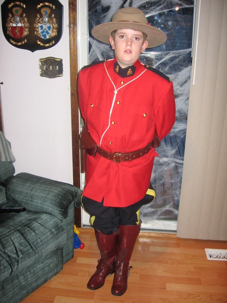 A boy wears an RCMP outfit.