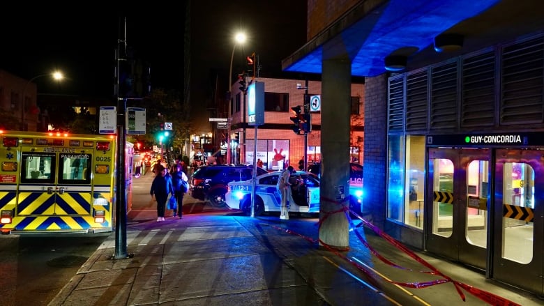 ambulance vehicle and police cars outside a Metro station. 