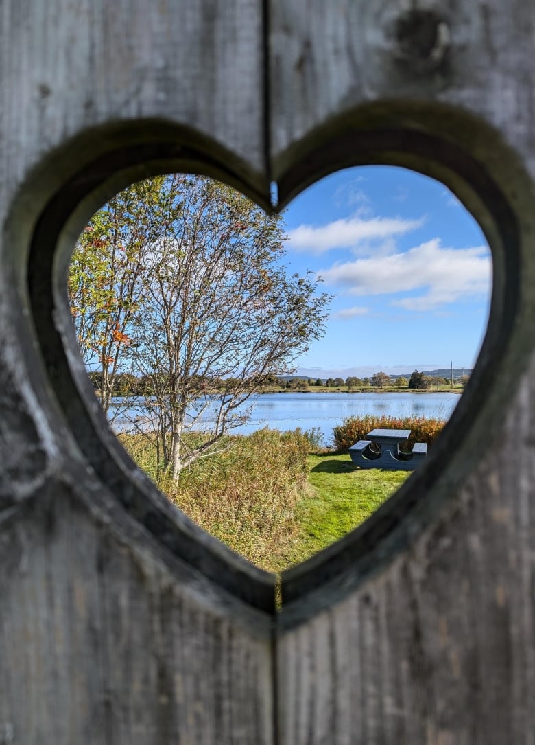 A shot of Kenny's Pond through a wooden heart.