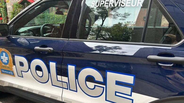 A Montreal police vehicle is parked on a street in downtown Montreal.